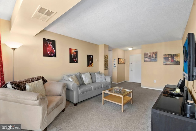 carpeted living room featuring visible vents, a textured ceiling, and baseboards