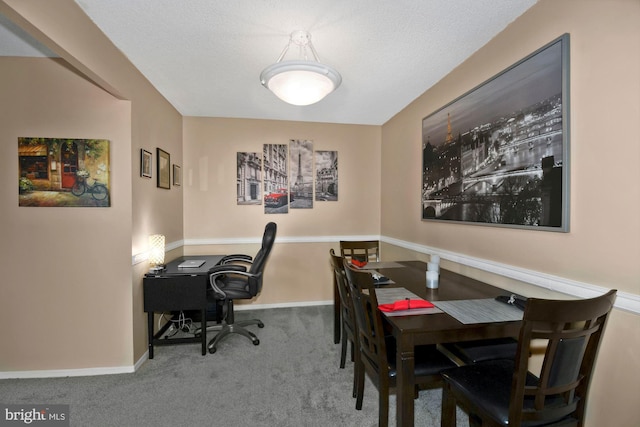 office space featuring light carpet, a textured ceiling, and baseboards