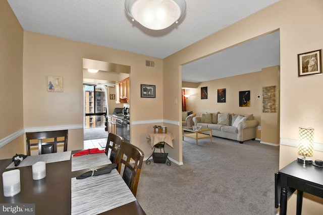 dining area with carpet, visible vents, and baseboards