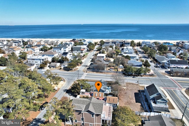 birds eye view of property with a water view and a residential view