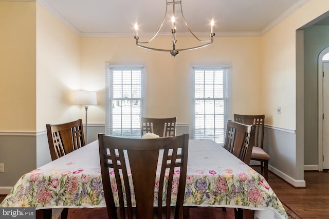 dining room with plenty of natural light, ornamental molding, and wood finished floors