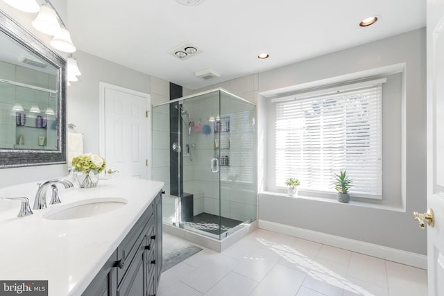 bathroom featuring recessed lighting, a stall shower, vanity, baseboards, and tile patterned floors