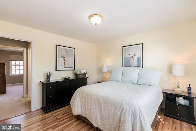 bedroom featuring baseboards and wood finished floors