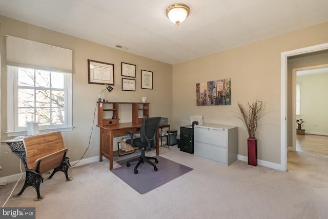 carpeted office with visible vents and baseboards