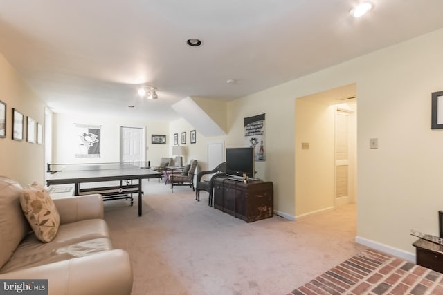 living room with light carpet and baseboards