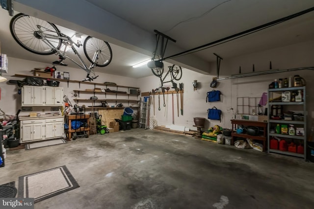 garage featuring a garage door opener and a workshop area