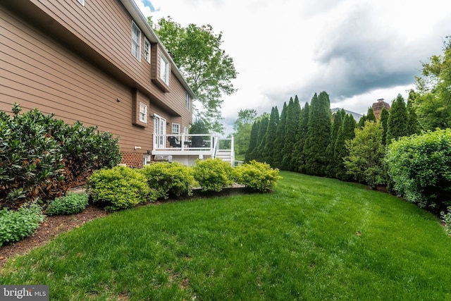 view of yard with a wooden deck