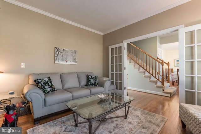 living room with baseboards, wood finished floors, stairs, crown molding, and french doors