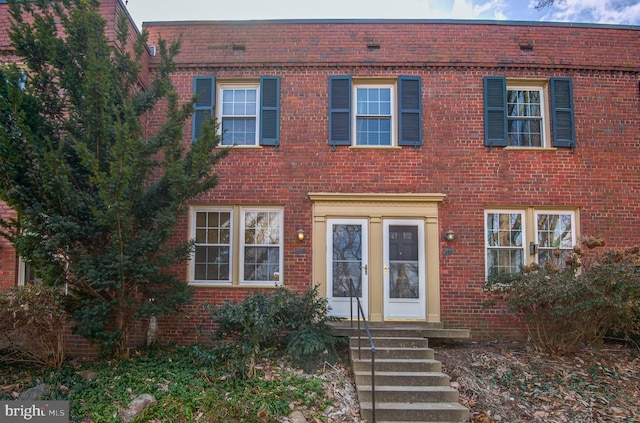 view of front of home featuring entry steps and brick siding