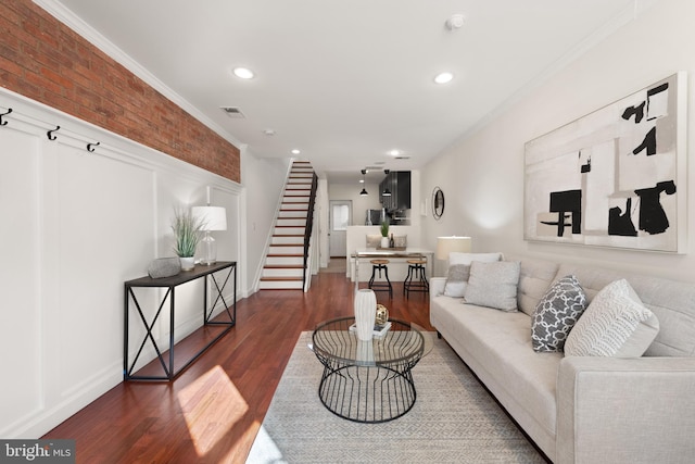 living area with recessed lighting, visible vents, stairs, dark wood finished floors, and crown molding