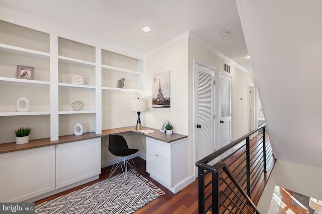 office space with visible vents, built in study area, ornamental molding, dark wood-type flooring, and recessed lighting