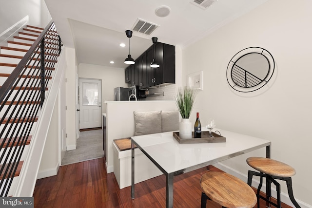 dining area featuring stairs, ornamental molding, dark wood finished floors, and visible vents