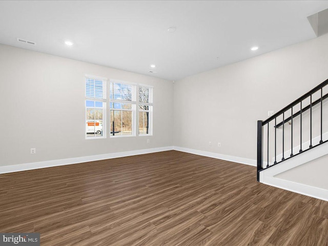 unfurnished living room featuring baseboards, visible vents, stairway, dark wood-style flooring, and recessed lighting