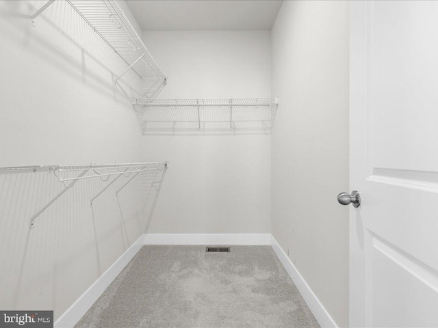 walk in closet with carpet floors and visible vents