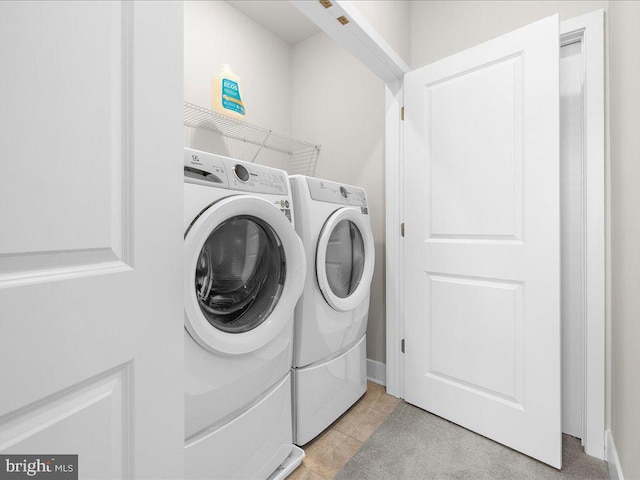 washroom featuring laundry area, light tile patterned floors, and independent washer and dryer