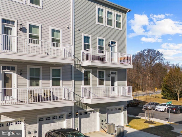 view of front of property featuring central AC and an attached garage