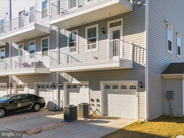 exterior space with a garage and central AC unit