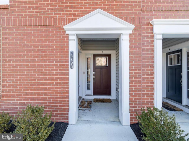 property entrance with brick siding