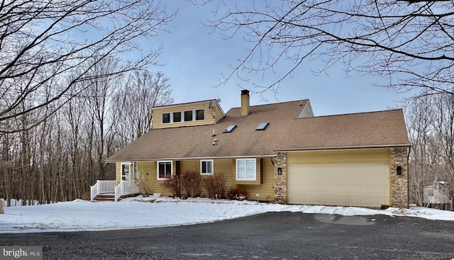 view of front of property featuring a garage, roof with shingles, and a chimney