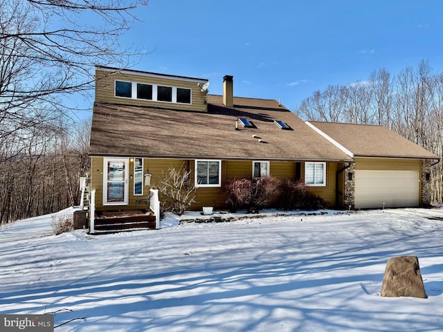 view of front of home featuring an attached garage and a chimney