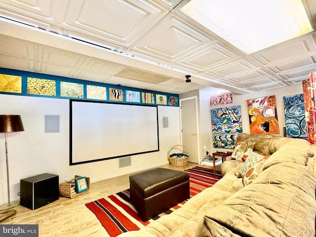 cinema room with an ornate ceiling and wood finished floors