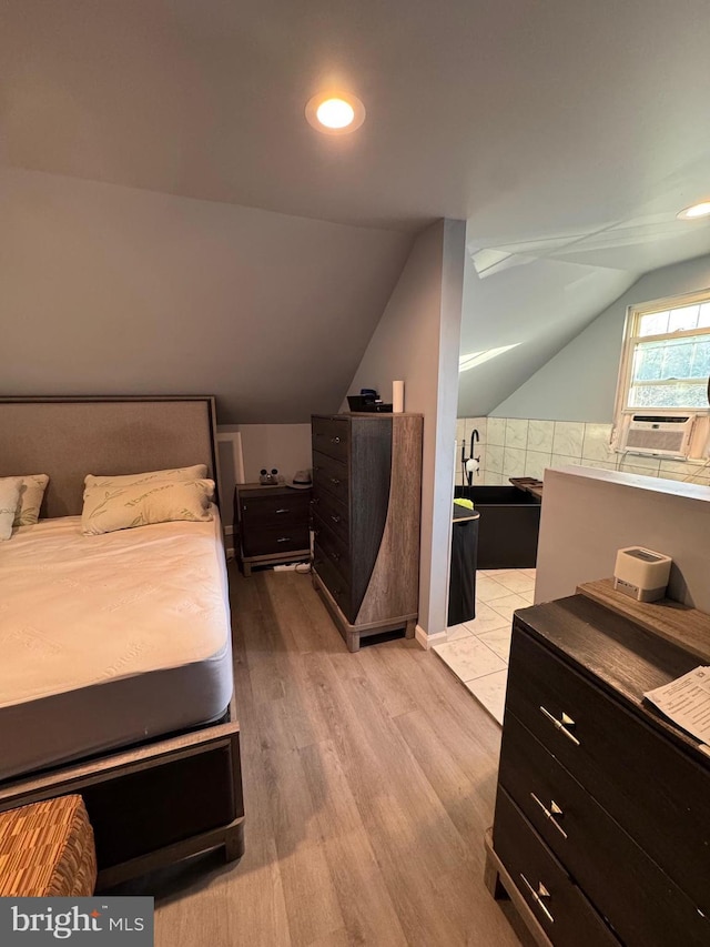 bedroom with lofted ceiling, cooling unit, light wood-style flooring, and recessed lighting