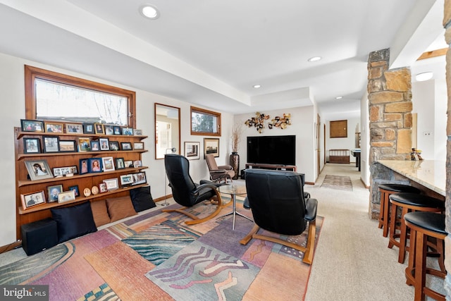 living room with recessed lighting, light colored carpet, and baseboards