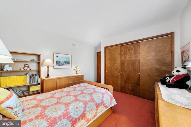 bedroom with carpet floors, a closet, and visible vents