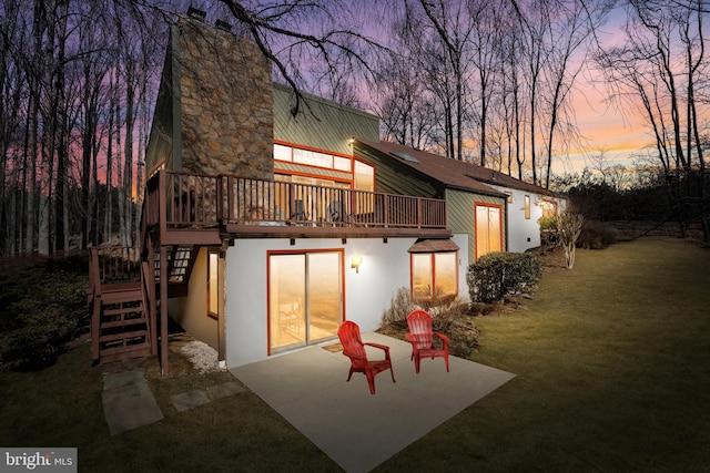 back of property with a yard, stucco siding, stairway, a patio area, and a deck