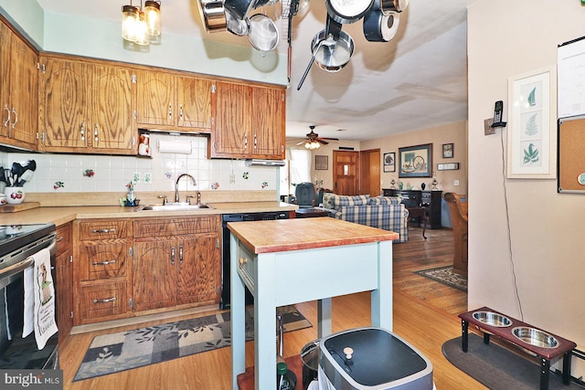 kitchen featuring brown cabinets, light countertops, and a sink