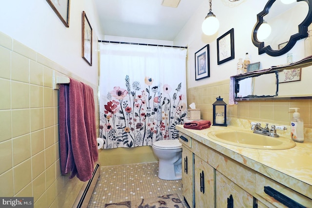 bathroom with tile patterned flooring, toilet, a shower with shower curtain, vanity, and tile walls