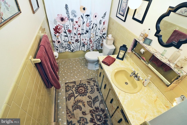 bathroom featuring tile walls, a shower with curtain, toilet, vanity, and tile patterned flooring