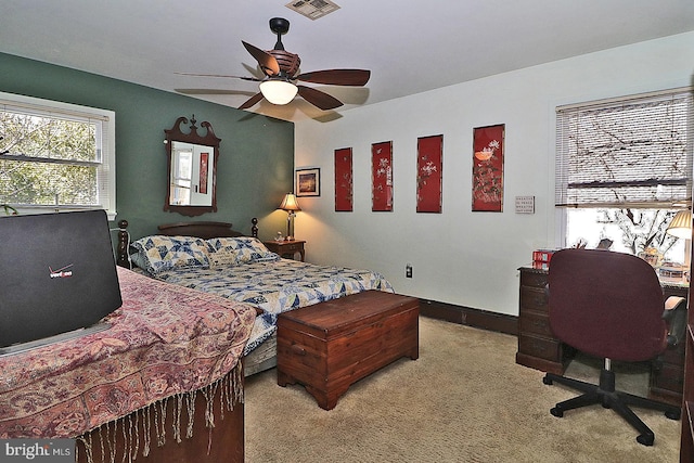 bedroom featuring ceiling fan, visible vents, baseboards, and light colored carpet