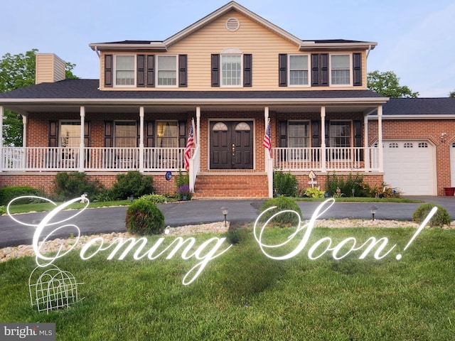 view of front facade featuring covered porch, a garage, brick siding, a front lawn, and a chimney