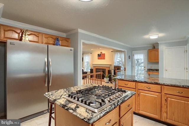 kitchen with crown molding, dark stone counters, stainless steel appliances, and marble finish floor