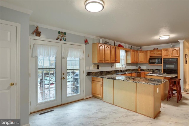 kitchen featuring black microwave, french doors, a peninsula, a healthy amount of sunlight, and visible vents