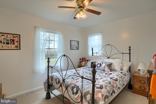carpeted bedroom featuring a ceiling fan, baseboards, ornamental molding, and multiple windows