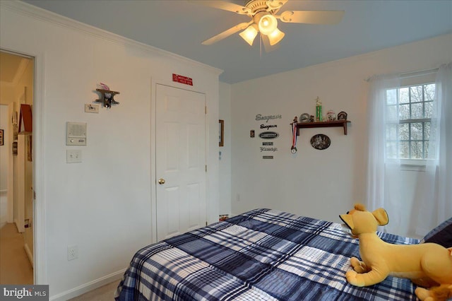 bedroom with baseboards, light colored carpet, ornamental molding, and ceiling fan