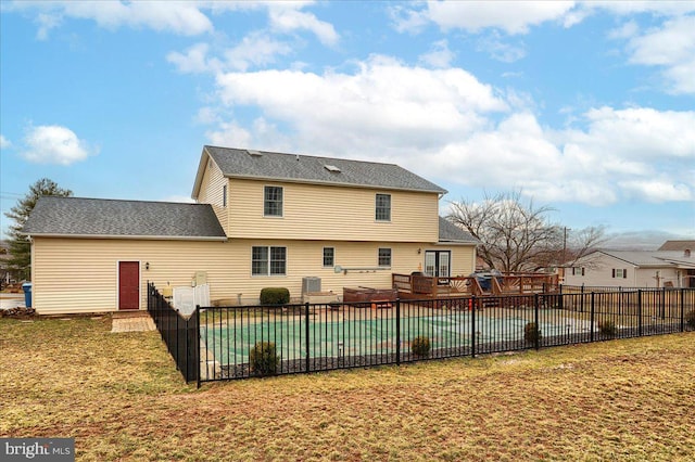 back of property with fence, a fenced in pool, a lawn, and a patio area