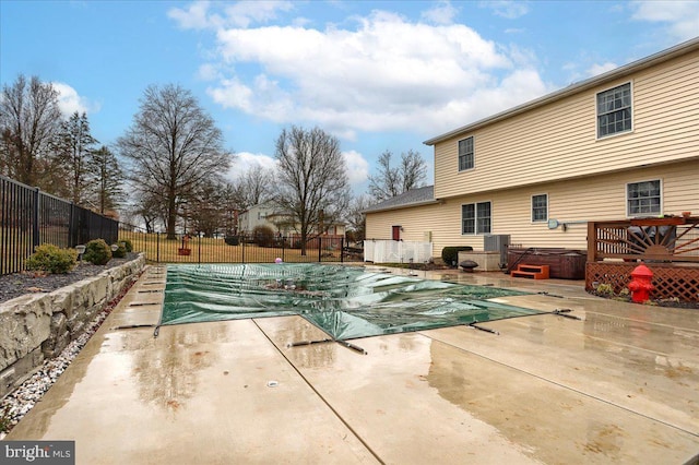view of pool with a fenced in pool, a hot tub, fence, and a patio