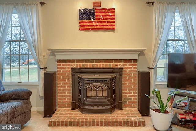 interior details featuring baseboards, carpet flooring, and a brick fireplace