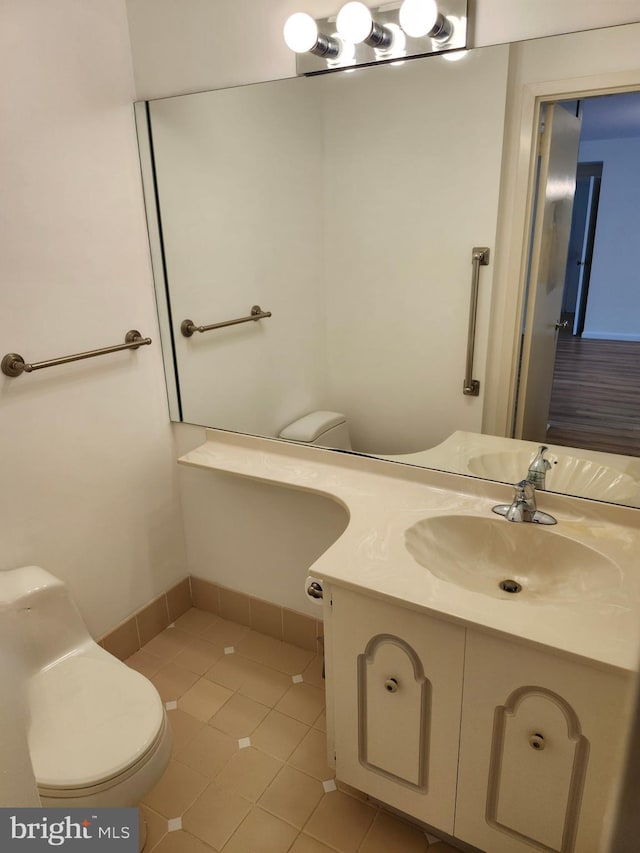 bathroom featuring tile patterned floors, vanity, and toilet