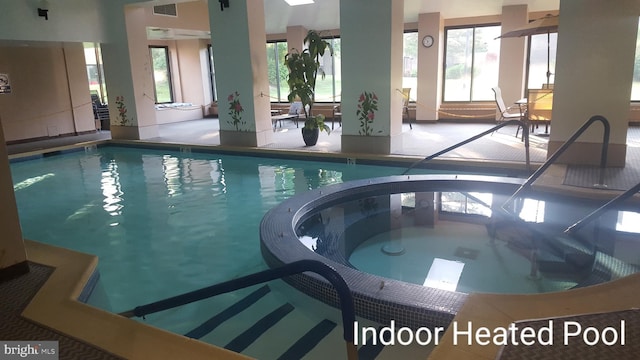 view of swimming pool with a pool with connected hot tub