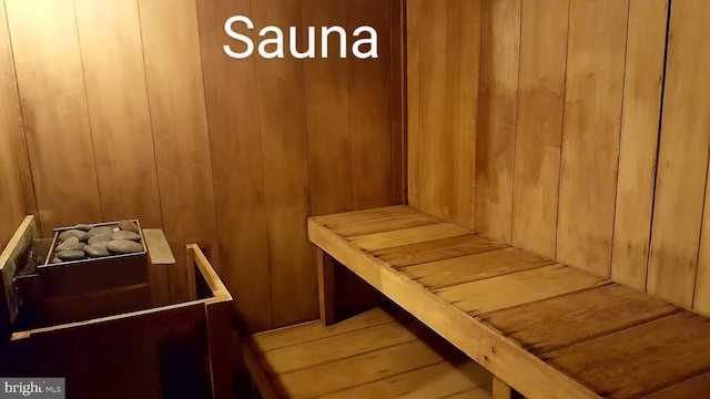 sauna / steam room with wood walls