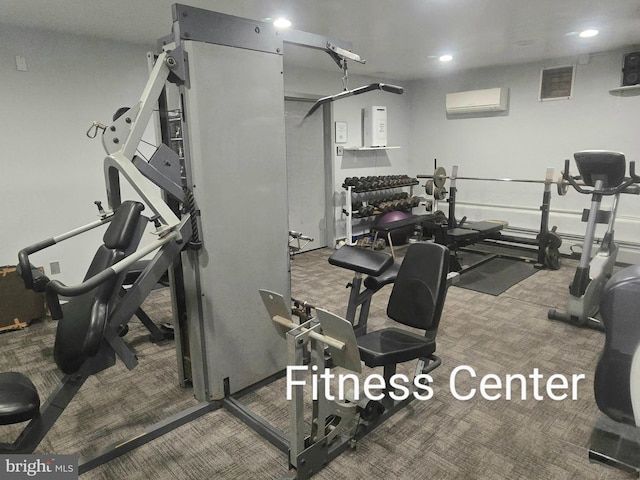 exercise room featuring carpet flooring, a wall unit AC, and recessed lighting