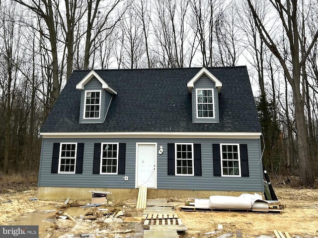 cape cod house with roof with shingles