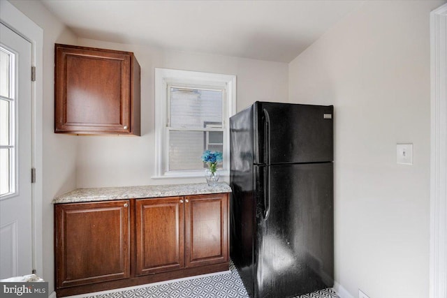 kitchen with freestanding refrigerator