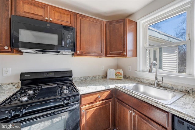 kitchen featuring black appliances, a sink, and brown cabinets