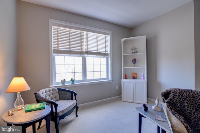 sitting room featuring carpet floors and baseboards