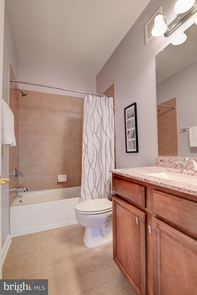 bathroom featuring toilet, vanity, shower / bath combo with shower curtain, and tile patterned floors